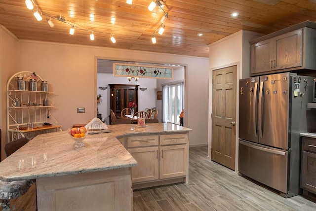 kitchen featuring a center island, wooden ceiling, light hardwood / wood-style flooring, stainless steel fridge, and light stone countertops