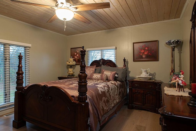 bedroom featuring ceiling fan, crown molding, wooden ceiling, and light wood-type flooring