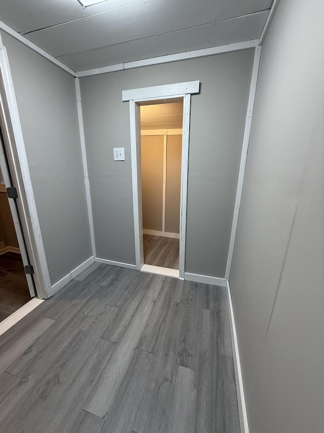 unfurnished bedroom featuring wood-type flooring and a closet