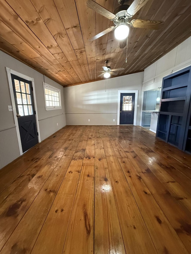 interior space with wood ceiling, ceiling fan, and wood-type flooring