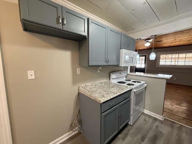 kitchen with dark hardwood / wood-style floors, hanging light fixtures, ornamental molding, kitchen peninsula, and white appliances