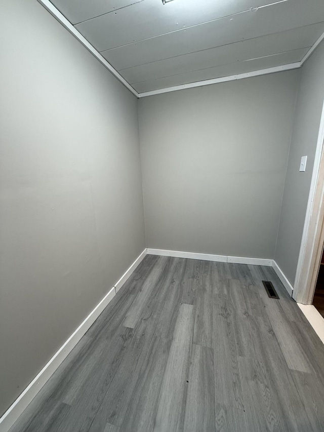 unfurnished room featuring ornamental molding and light hardwood / wood-style floors