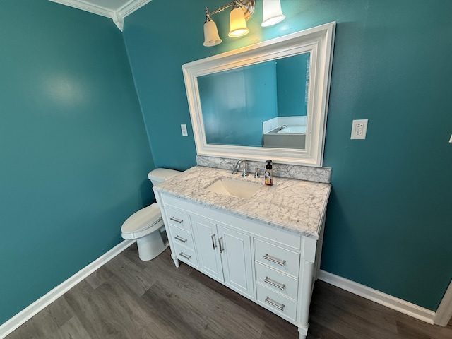 bathroom with vanity, hardwood / wood-style floors, ornamental molding, and toilet