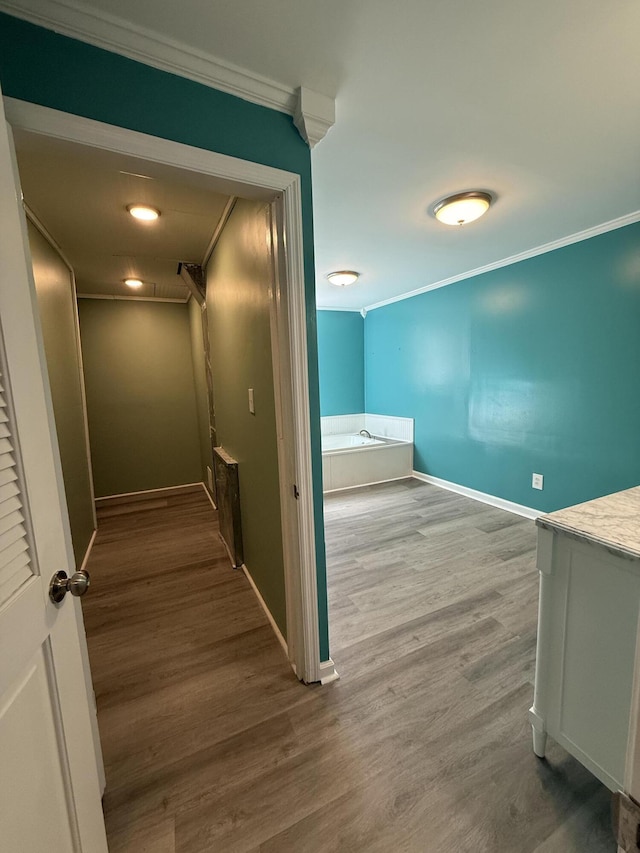 corridor featuring hardwood / wood-style flooring and ornamental molding