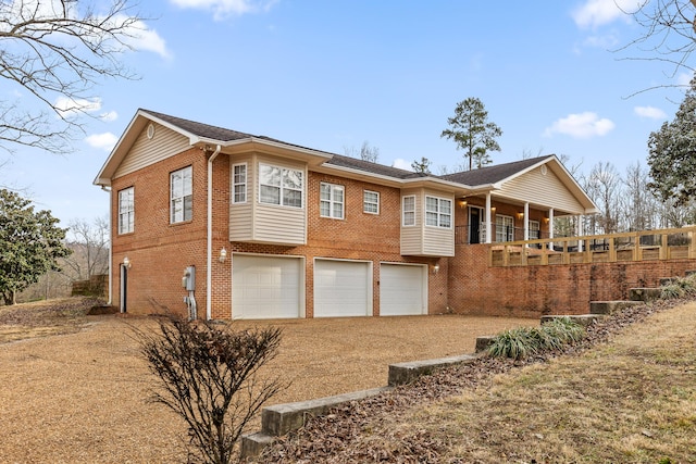 back of house featuring a garage and a balcony