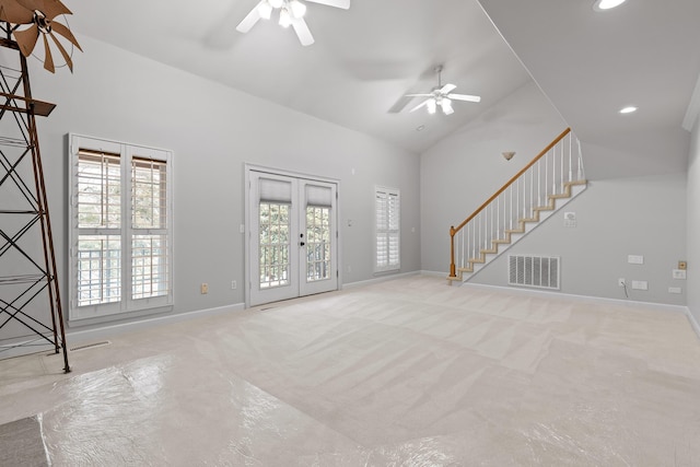 unfurnished living room with french doors, ceiling fan, light colored carpet, and high vaulted ceiling