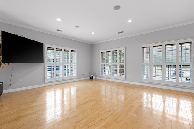 unfurnished living room with ornamental molding and light hardwood / wood-style flooring