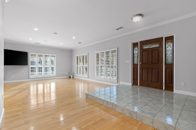 foyer featuring ornamental molding and light hardwood / wood-style floors