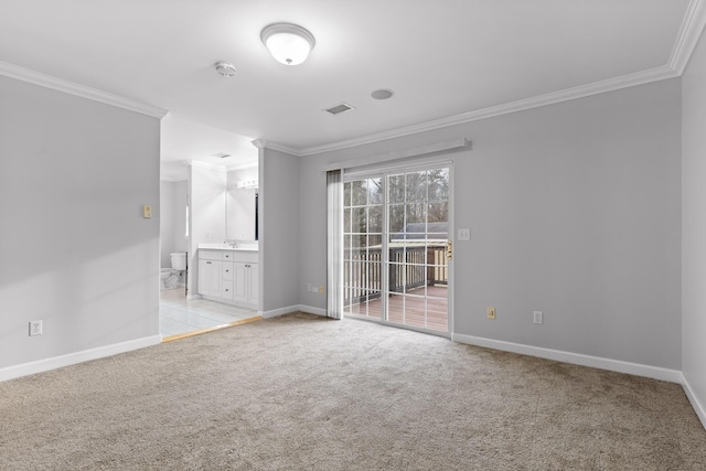 unfurnished room featuring light carpet, sink, and ornamental molding