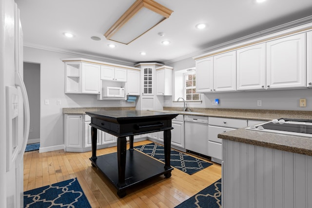 kitchen featuring white cabinetry, white appliances, crown molding, and hardwood / wood-style flooring