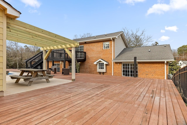 wooden deck featuring a patio area and a pergola