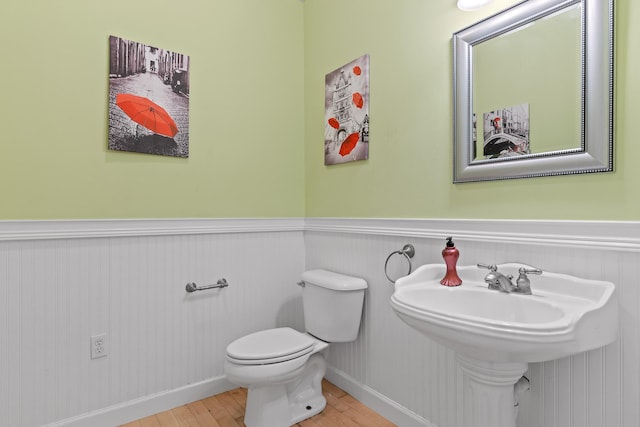 bathroom with wood-type flooring and toilet