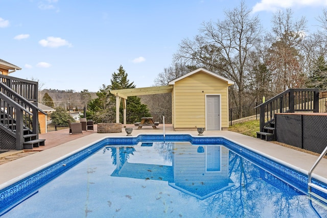 view of pool with a storage shed and a patio area