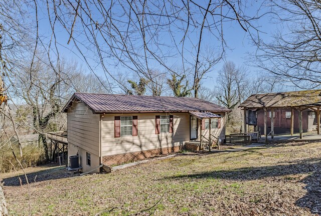 view of home's exterior with a lawn and a deck