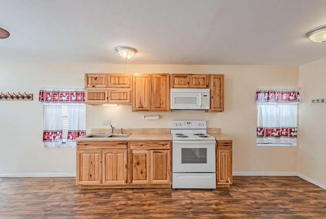 kitchen featuring white appliances, baseboards, a sink, and dark wood-style flooring