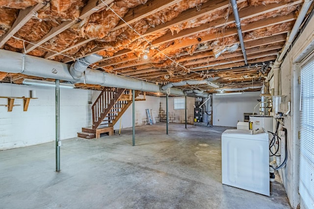 basement with stairs and washer / dryer