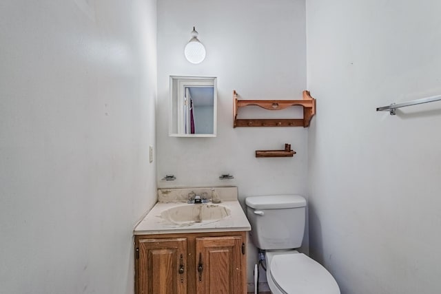 bathroom with toilet and vanity