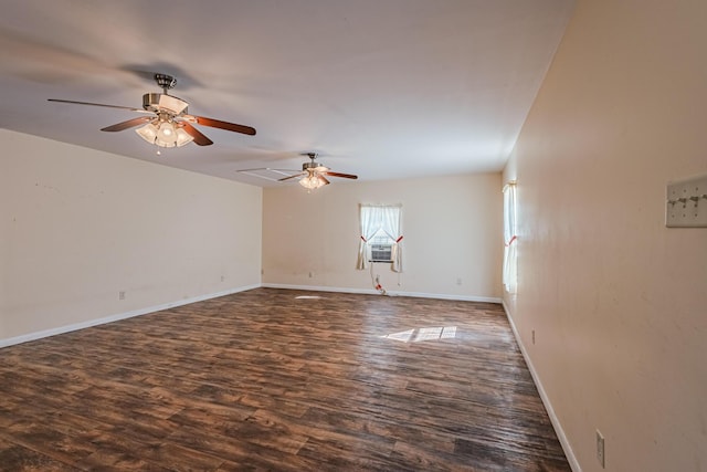 empty room featuring ceiling fan, baseboards, and dark wood-style flooring