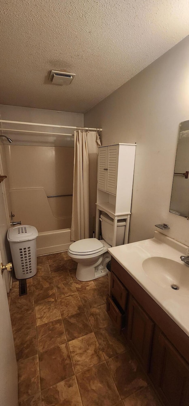 full bath with visible vents, toilet, vaulted ceiling, a textured ceiling, and vanity