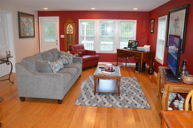 living area with baseboards, recessed lighting, and light wood finished floors