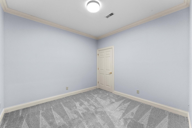 unfurnished room featuring baseboards, ornamental molding, visible vents, and carpet