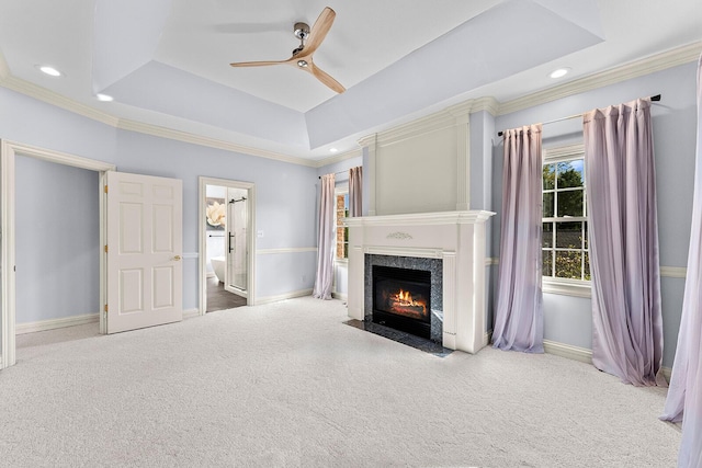 unfurnished living room featuring ornamental molding, carpet, and a ceiling fan