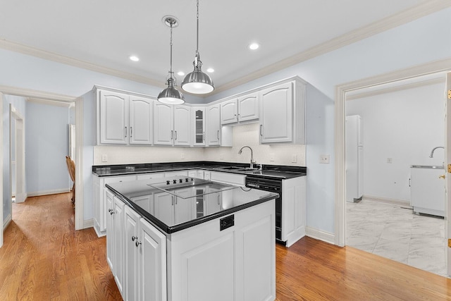 kitchen with dark countertops, white cabinetry, black appliances, decorative light fixtures, and ornamental molding