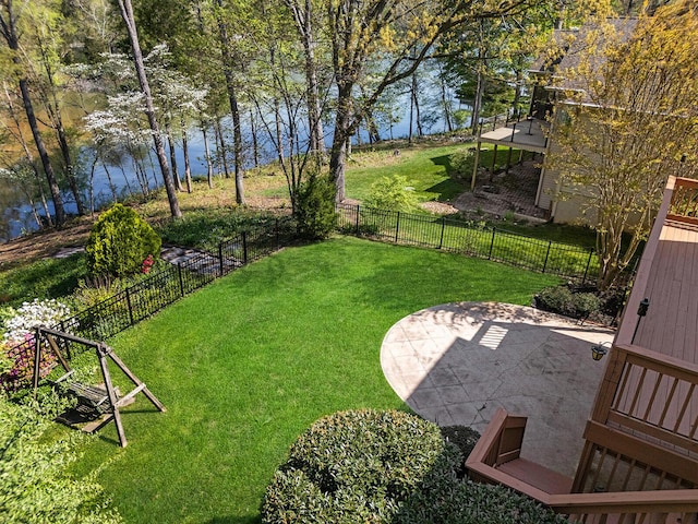 view of yard with a water view, a patio area, and a fenced backyard