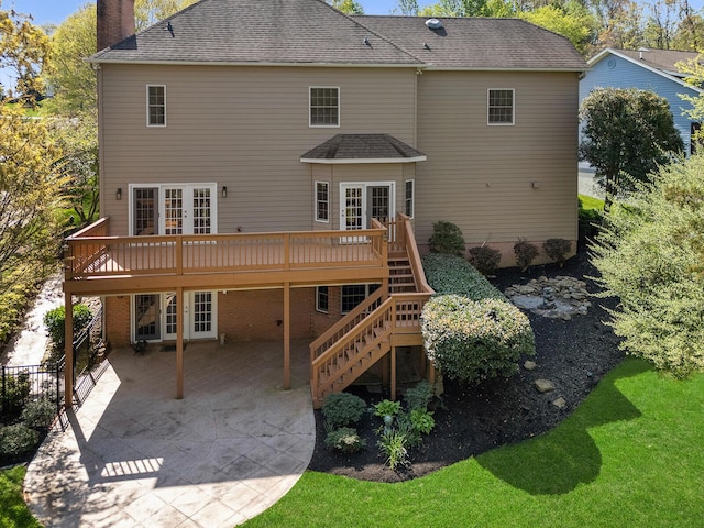 rear view of property featuring a deck, a patio, french doors, and a chimney