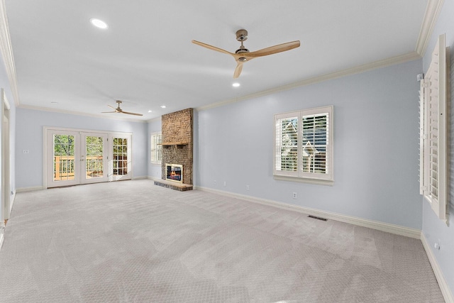unfurnished living room featuring carpet flooring, crown molding, visible vents, and ceiling fan