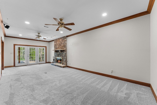 unfurnished living room with baseboards, ornamental molding, ceiling fan, and light colored carpet