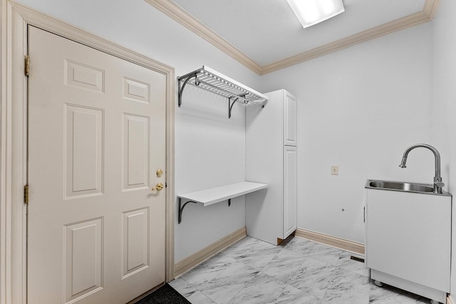 washroom featuring baseboards, marble finish floor, ornamental molding, and a sink
