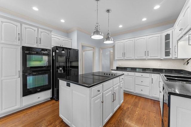 kitchen featuring a sink, dark countertops, white cabinets, black appliances, and ornamental molding