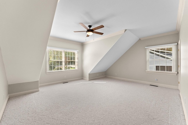 additional living space featuring baseboards, visible vents, ceiling fan, and carpet floors