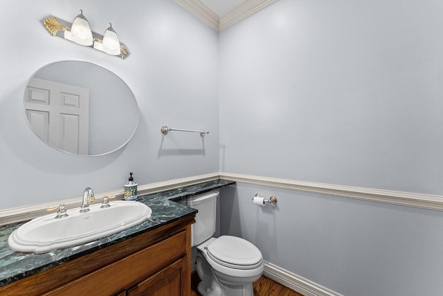 bathroom featuring vanity, ornamental molding, toilet, and wood finished floors