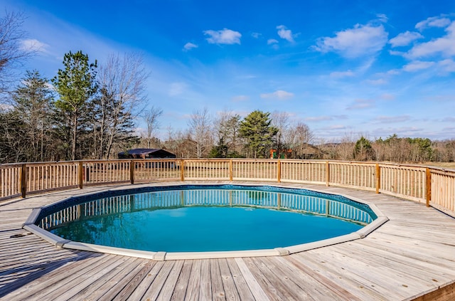 view of swimming pool with a deck