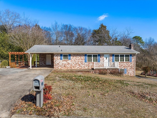 ranch-style home featuring a carport and covered porch