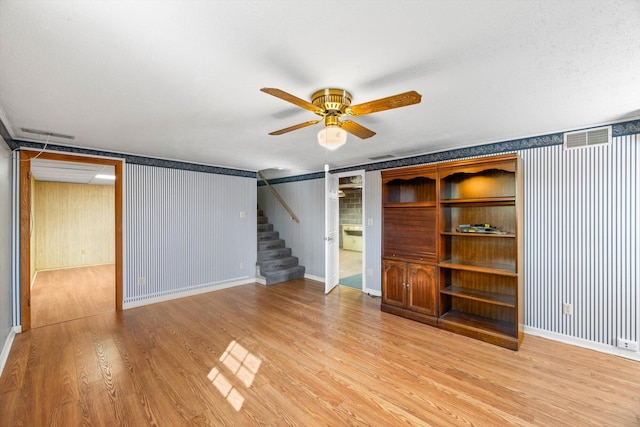 unfurnished living room with hardwood / wood-style floors and ceiling fan