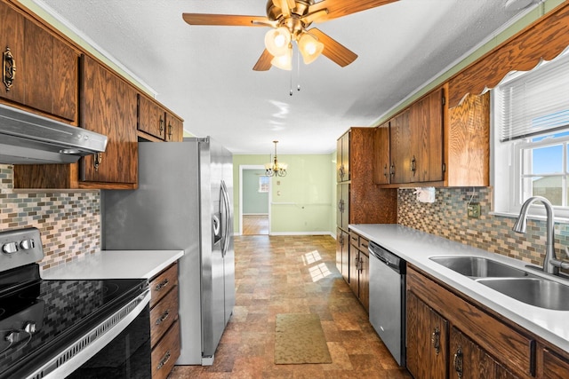 kitchen featuring sink, decorative light fixtures, stainless steel appliances, and backsplash