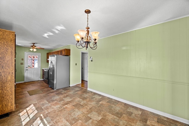 kitchen featuring stainless steel refrigerator with ice dispenser, ceiling fan with notable chandelier, and a textured ceiling