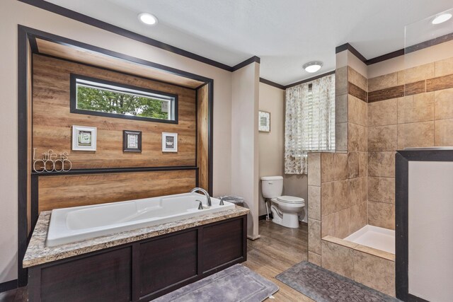308 S Crisp Ln, Decatur, TN 37322 - bathroom with toilet, a bath, wood finished floors, crown molding, and baseboards