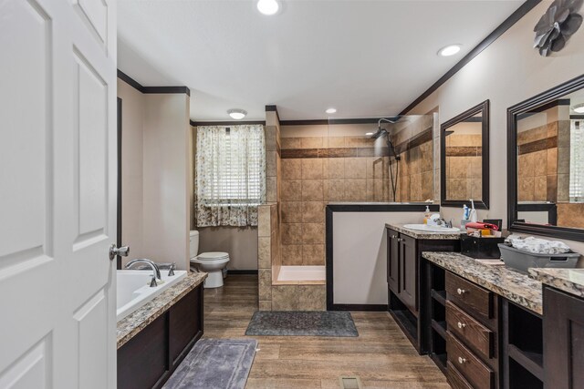 308 S Crisp Ln, Decatur, TN 37322 - full bath with walk in shower, vanity, wood finished floors, a bath, and toilet