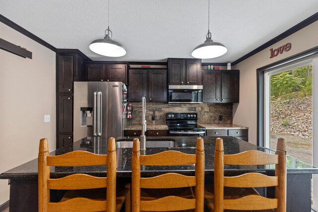 308 S Crisp Ln, Decatur, TN 37322 - kitchen with stainless steel appliances, crown molding, decorative backsplash, decorative light fixtures, and dark brown cabinets