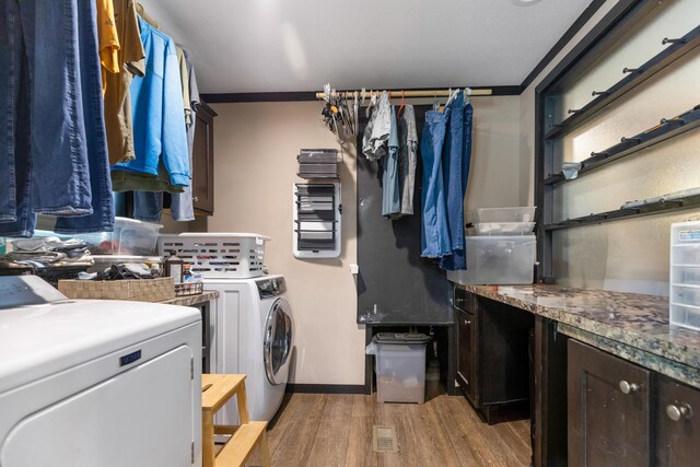 308 S Crisp Ln, Decatur, TN 37322 - washroom with independent washer and dryer, light wood-style floors, and cabinet space