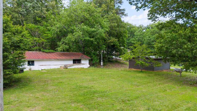 308 S Crisp Ln, Decatur, TN 37322 - view of green lawn featuring an outbuilding and a storage unit