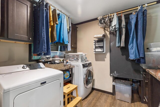 308 S Crisp Ln, Decatur, TN 37322 - laundry room with washing machine and clothes dryer, light wood-style floors, cabinet space, and baseboards
