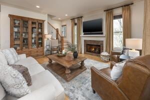 2560 Spring Creek Dr NE Lot 2 & 3, Cleveland, TN 37311 - living room featuring a lit fireplace, stairway, and recessed lighting