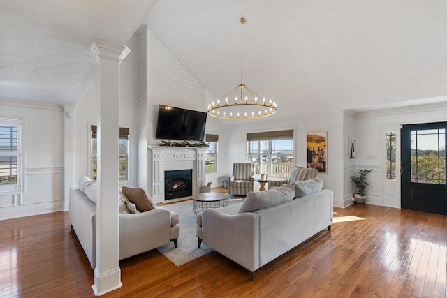living room featuring hardwood / wood-style flooring, plenty of natural light, and a fireplace with flush hearth