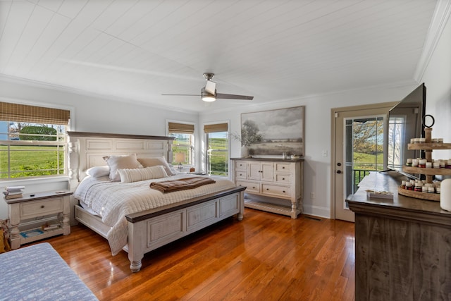 bedroom featuring access to exterior, crown molding, a ceiling fan, wood-type flooring, and baseboards