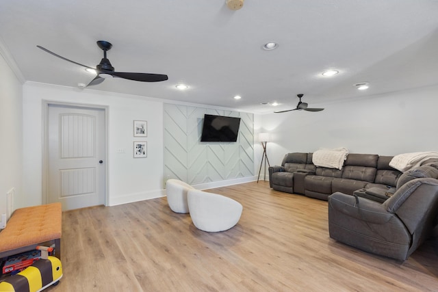 living area with wood finished floors, recessed lighting, crown molding, and ceiling fan